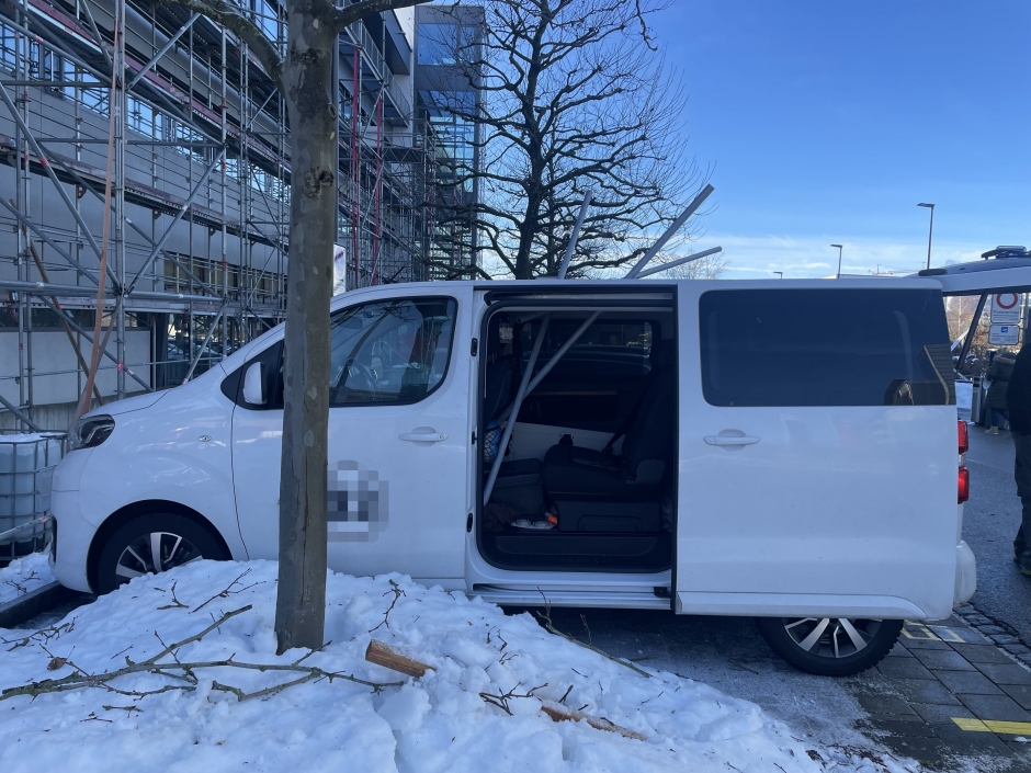 Weisser Lieferwagen mit Metallrohren durch das Dach.